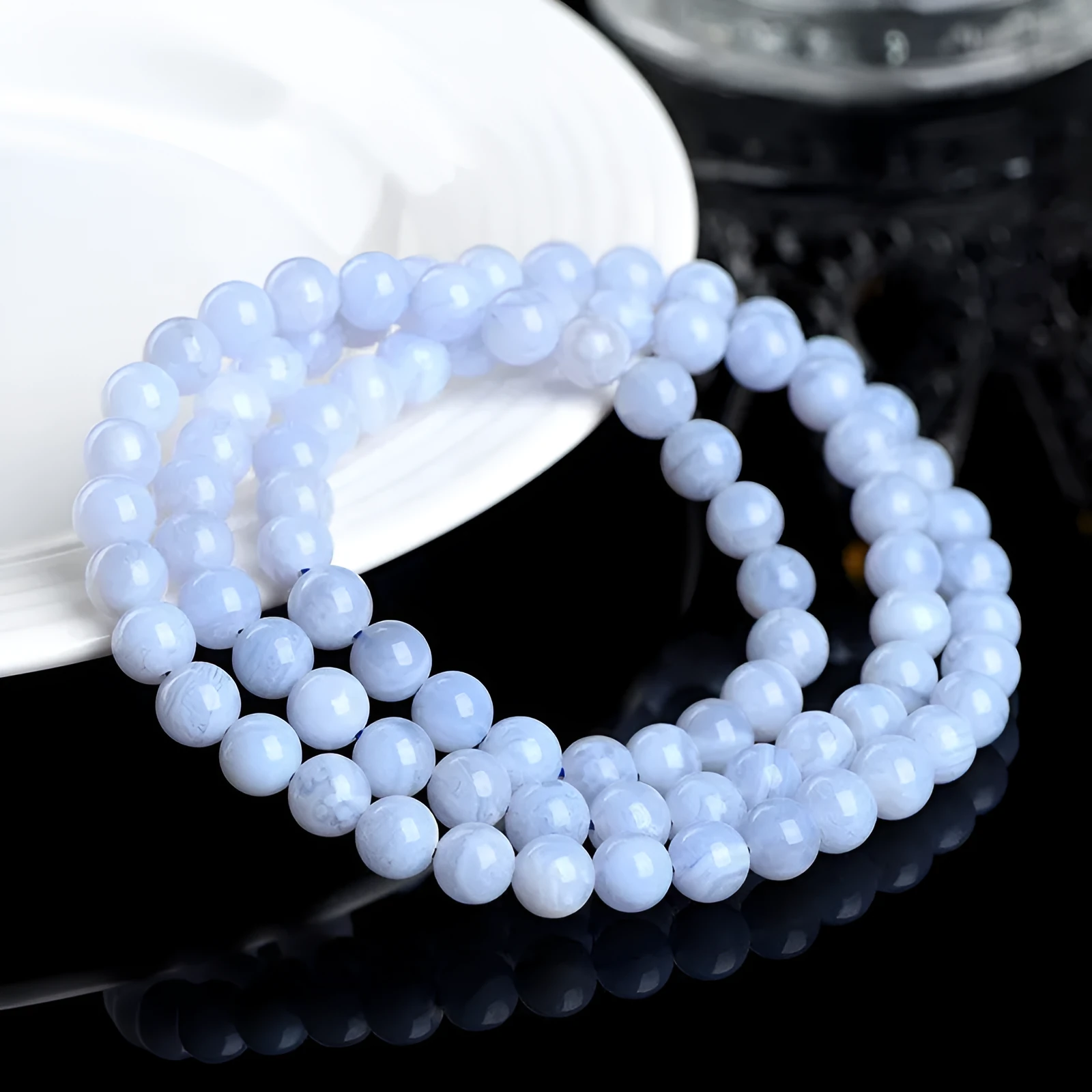 Blue agate bracelet with Ruyi symbol and scattered beads measuring 6-6.8mm.