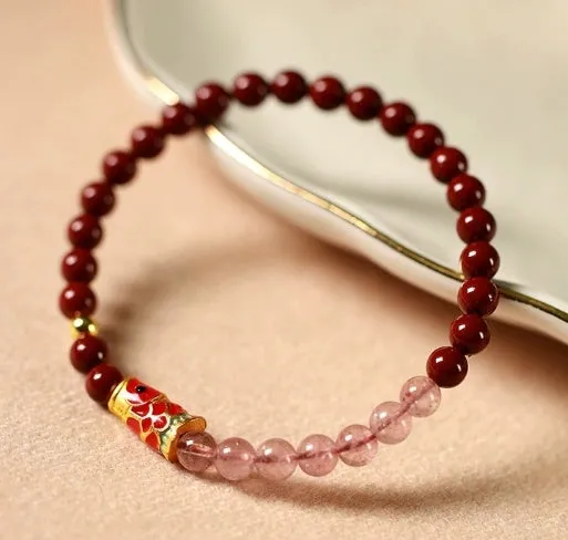 Hand-woven purple gold sand and strawberry quartz koi bracelet with crystal and pearl beads on a light background.