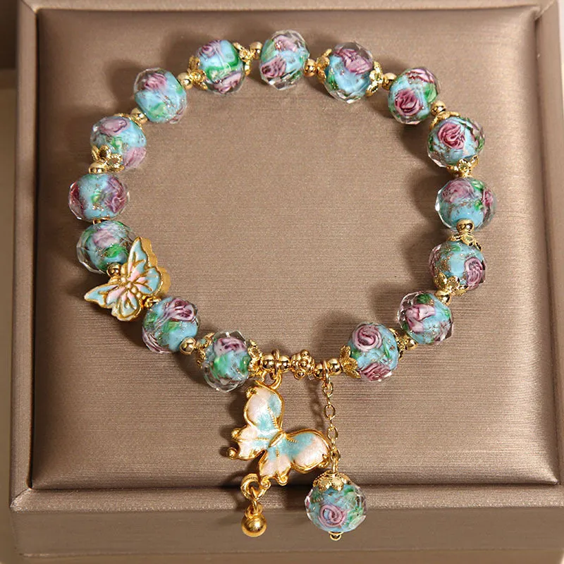 Women's rose garden bracelet with coloured glaze butterfly charm in blue, Japanese Korean style