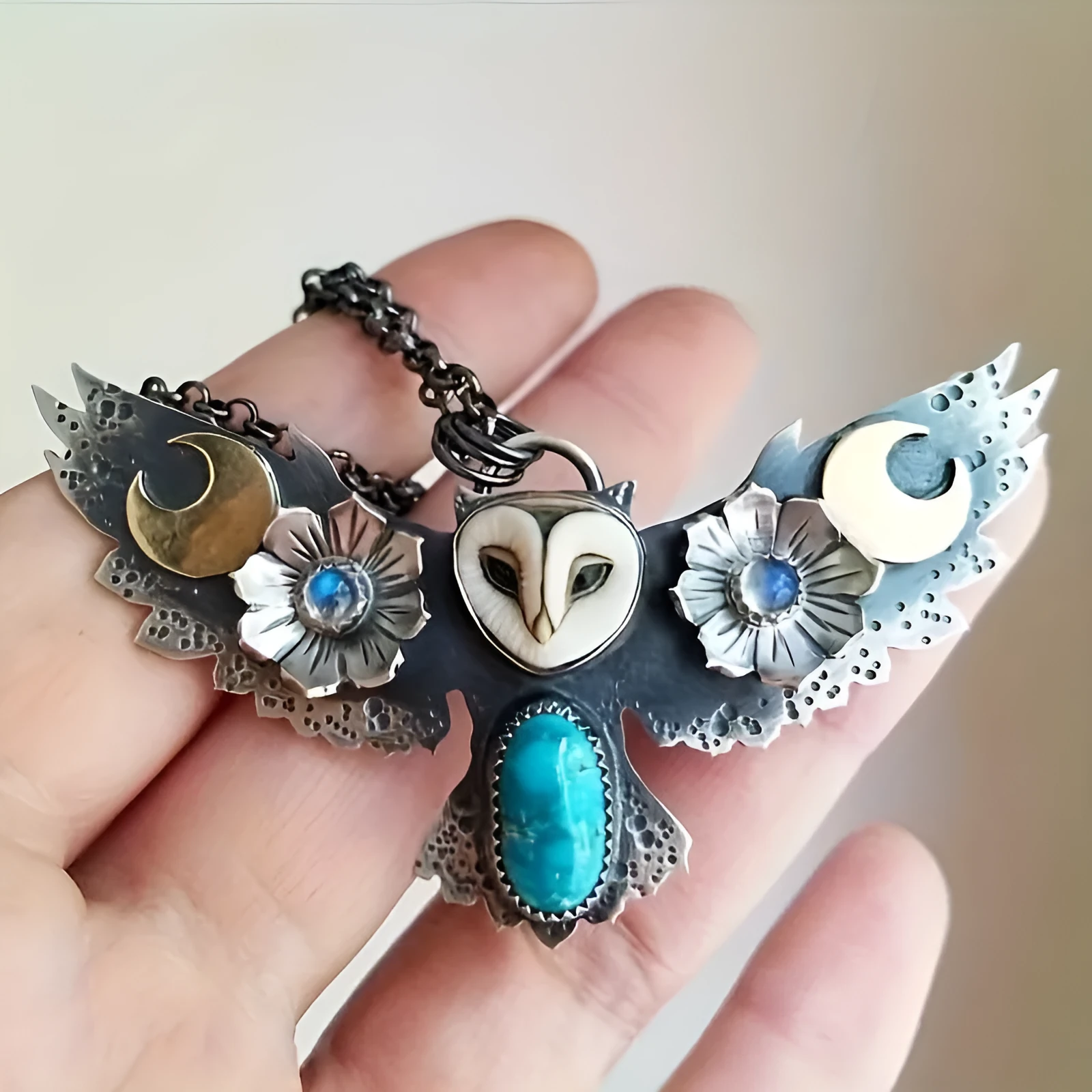 Silver electroplated alloy necklace with owl, moon, and flower pendant on unisex chain