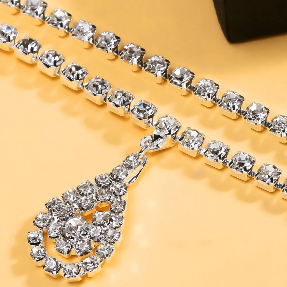 Gold rhinestone waist chain with water drop pendant and tassel detailing on adjustable 115 cm chain