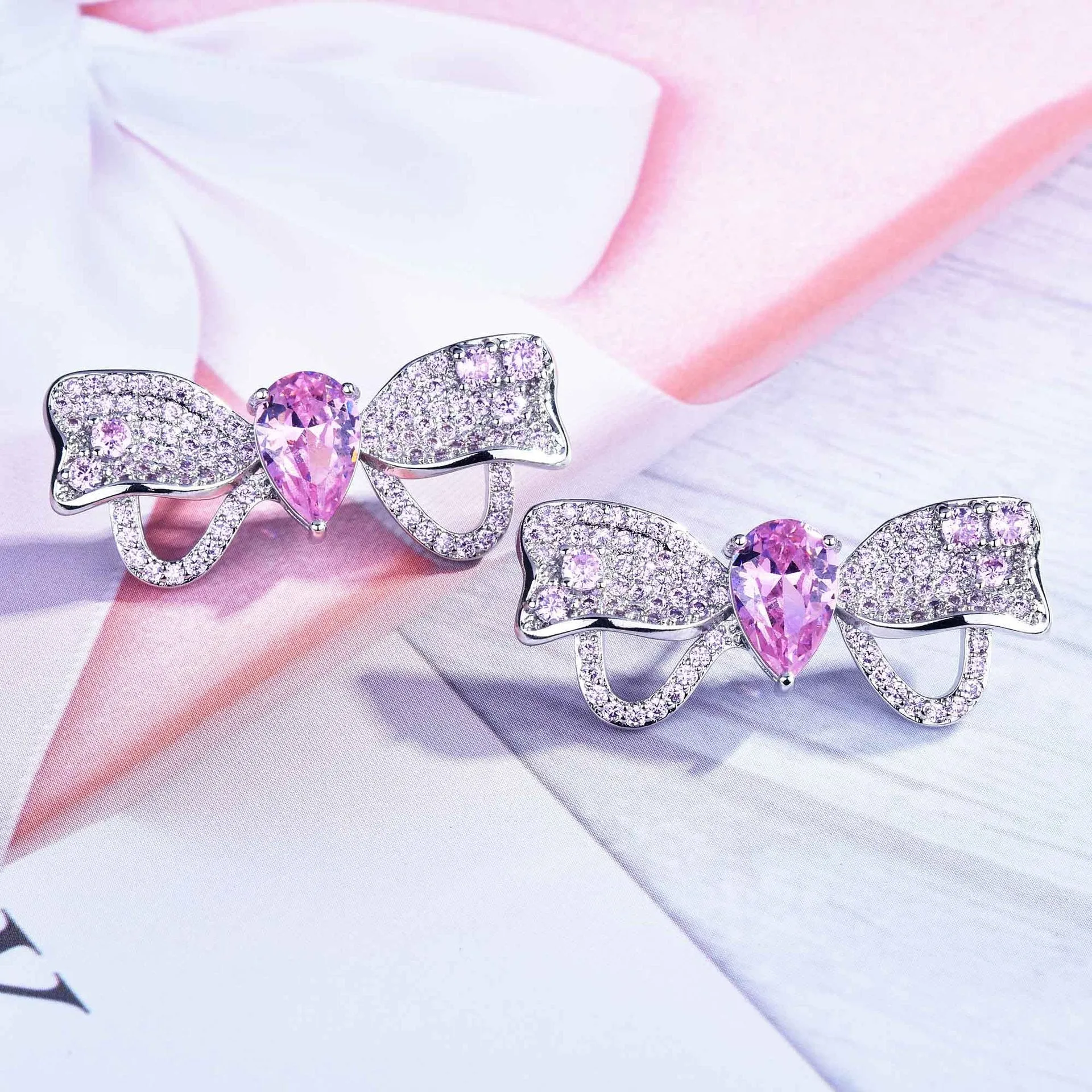 Full diamond bow jewellery set with necklace, bracelet, and ear studs in copper with mixed gem inlay