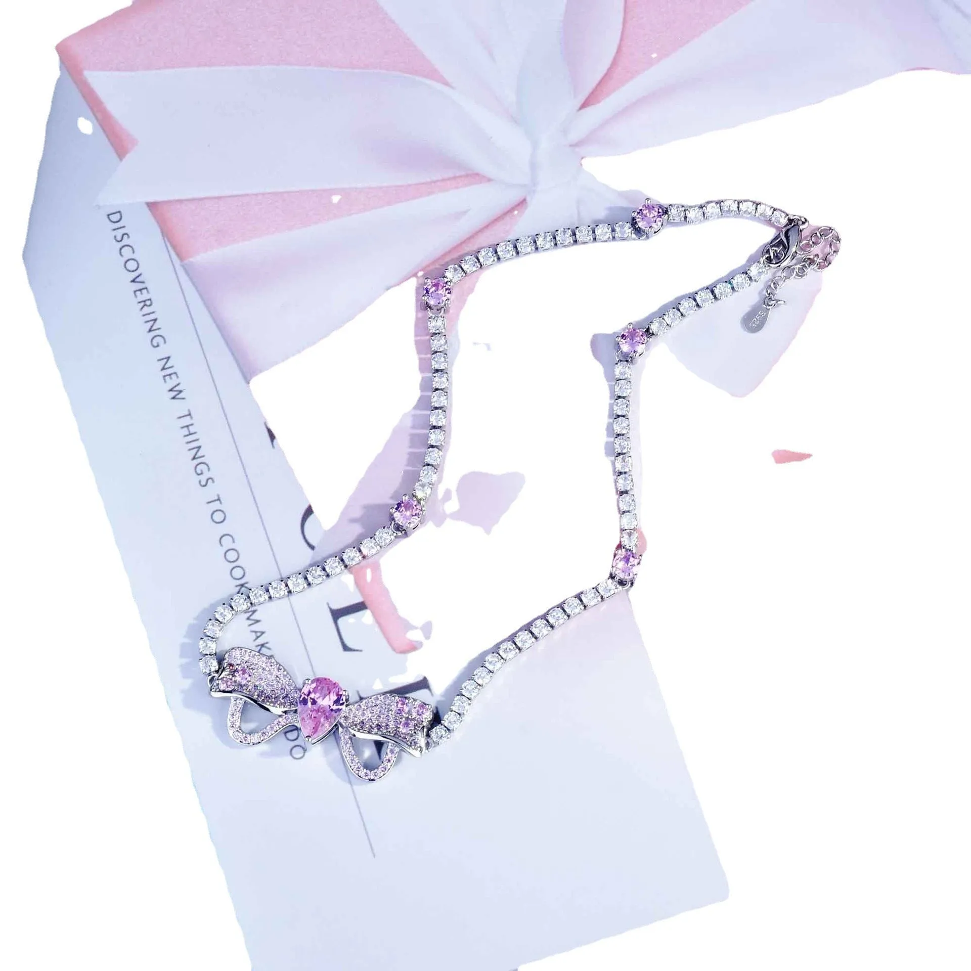 Full diamond bow jewellery set with necklace, bracelet, and ear studs in copper with mixed gem inlay
