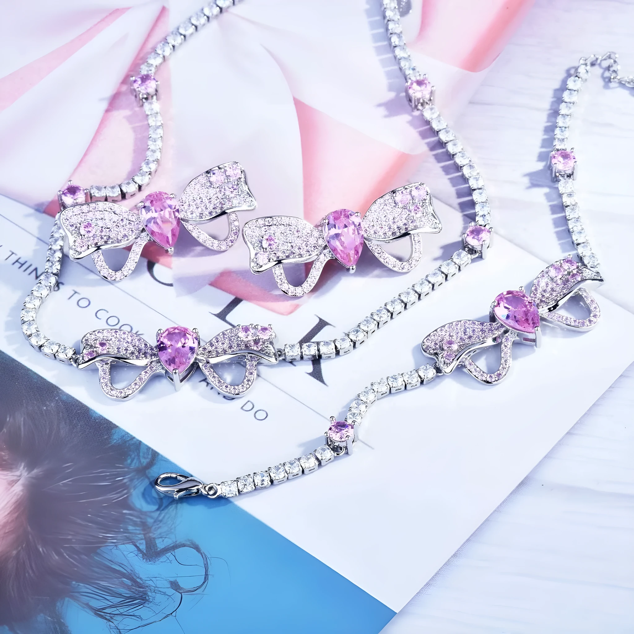 Full diamond bow jewellery set with necklace, bracelet, and ear studs in copper with mixed gem inlay