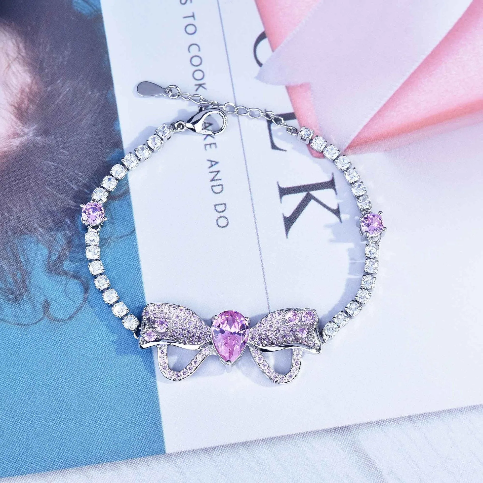 Full diamond bow jewellery set with necklace, bracelet, and ear studs in copper with mixed gem inlay