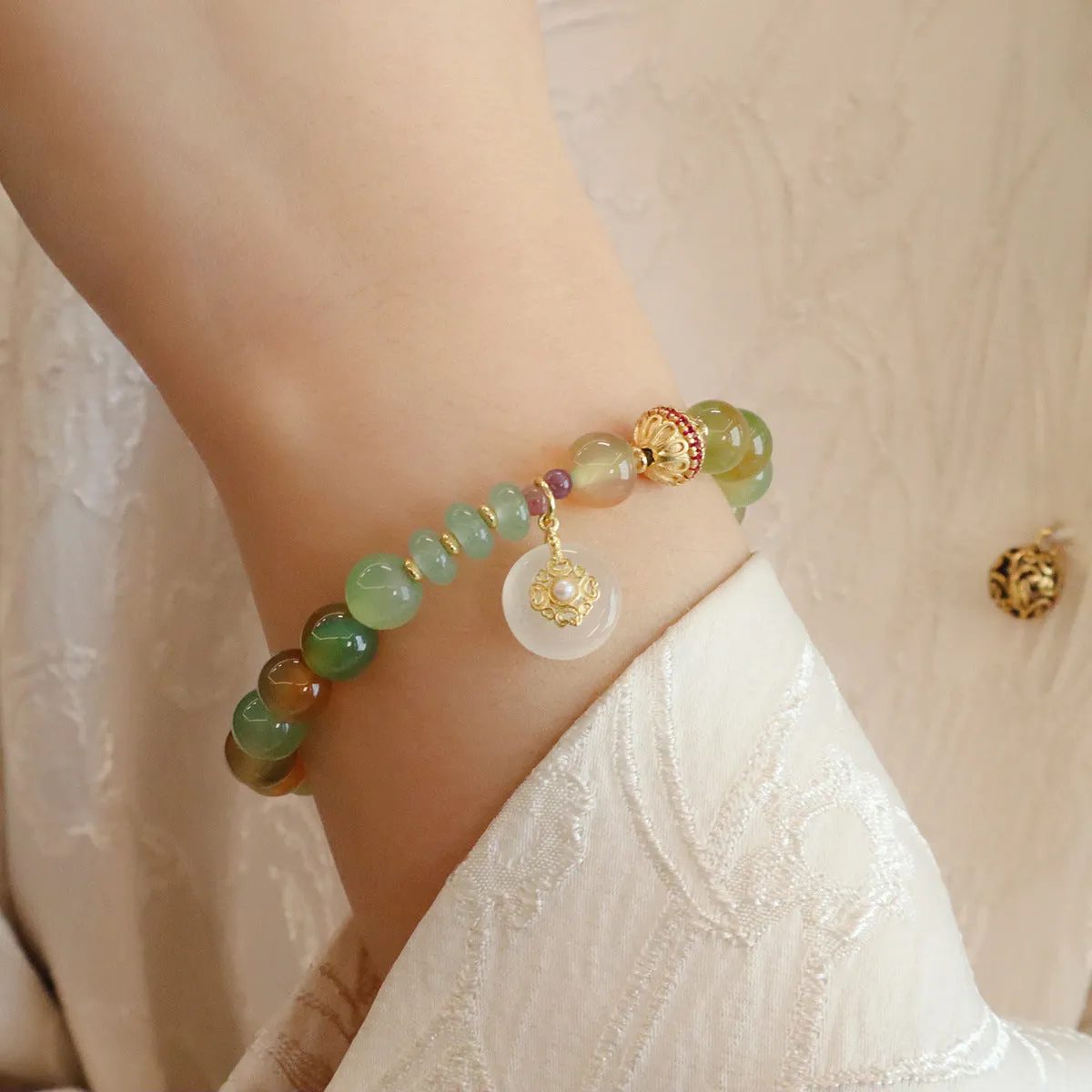 Natural peacock green agate bracelet with 8mm beads and butterfly peace buckle on white background