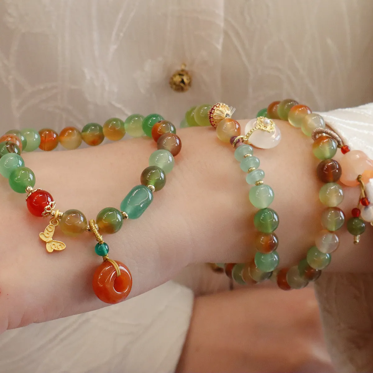 Natural peacock green agate bracelet with 8mm beads and butterfly peace buckle on white background