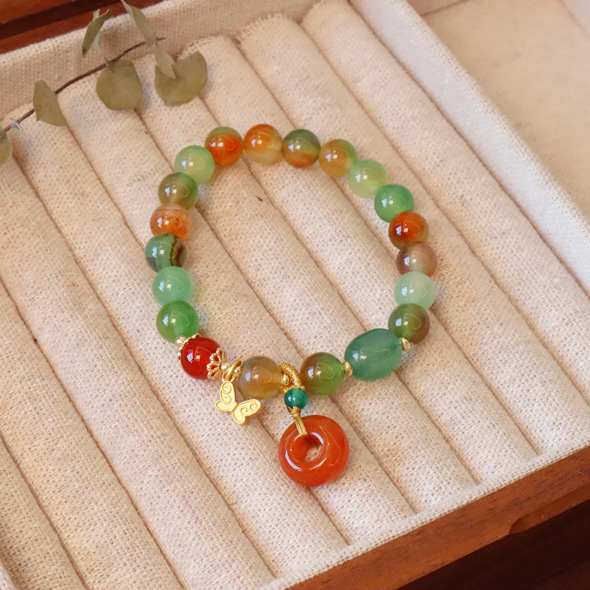 Natural peacock green agate bracelet with 8mm beads and butterfly peace buckle on white background
