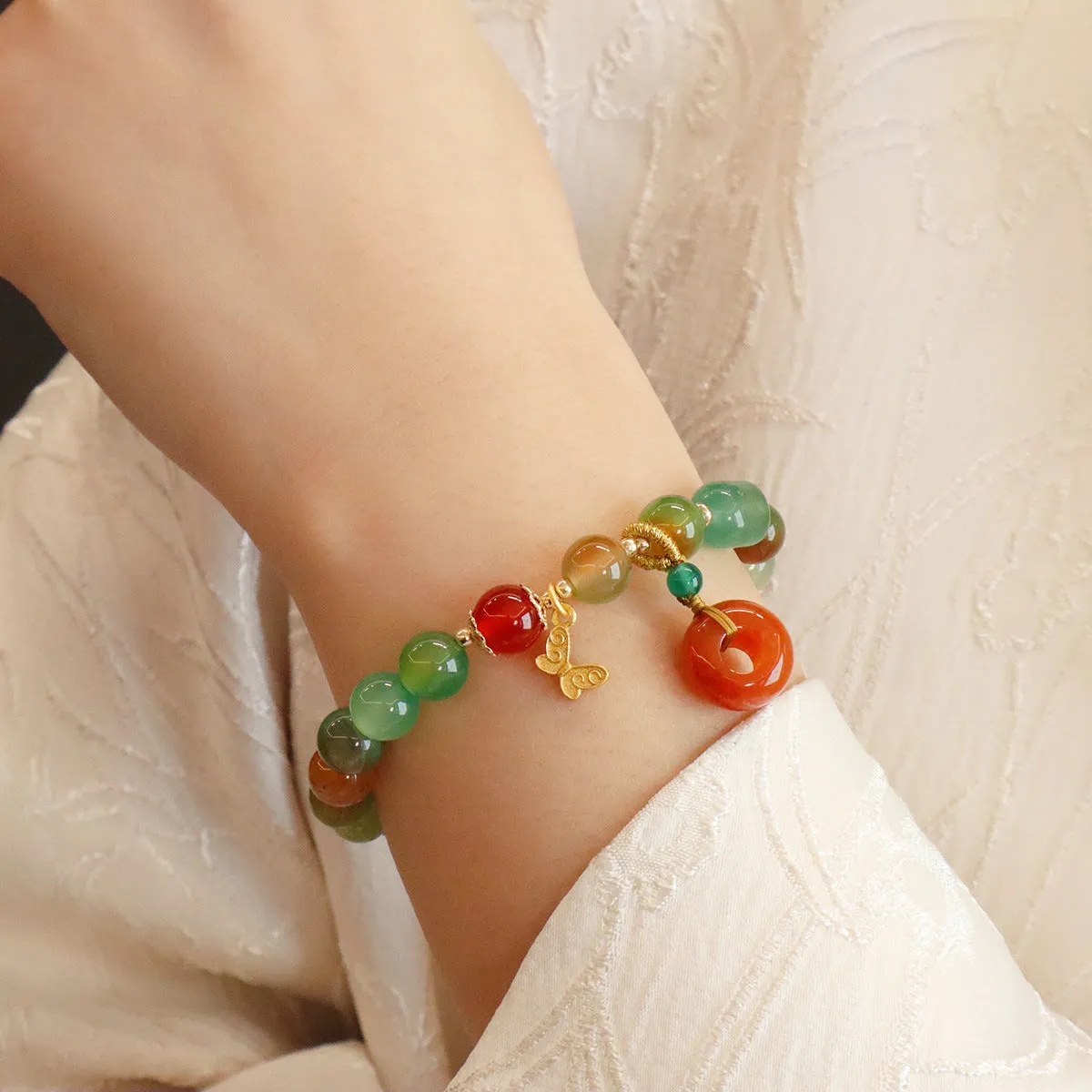 Natural peacock green agate bracelet with 8mm beads and butterfly peace buckle on white background