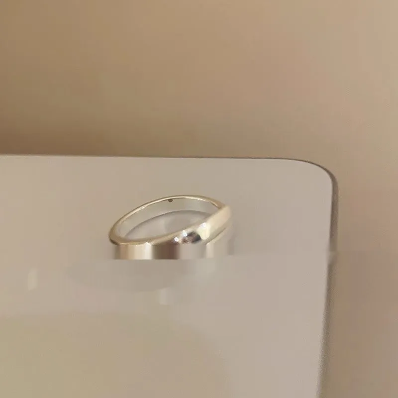 Geometric bow adjustable open ring in copper with electroplated gold finish on finger