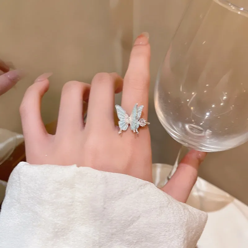 Geometric bow adjustable open ring in copper with electroplated gold finish on finger