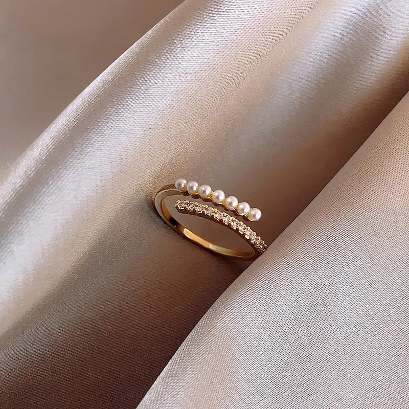 Geometric bow adjustable open ring in copper with electroplated gold finish on finger