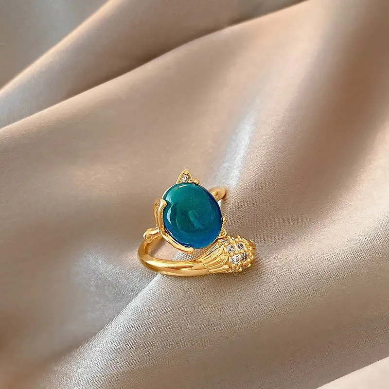 Geometric bow adjustable open ring in copper with electroplated gold finish on finger