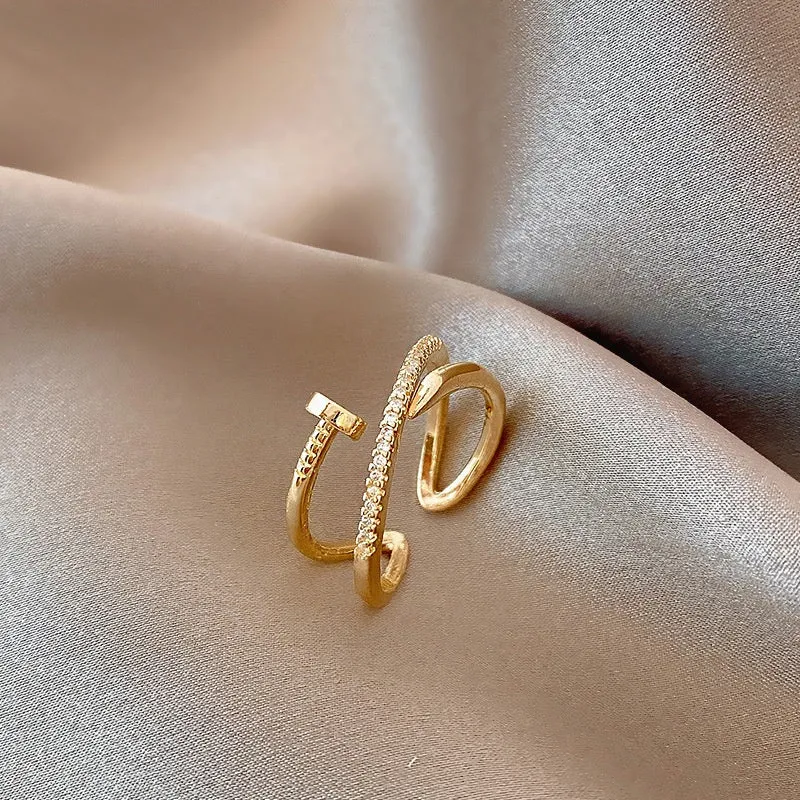 Geometric bow adjustable open ring in copper with electroplated gold finish on finger