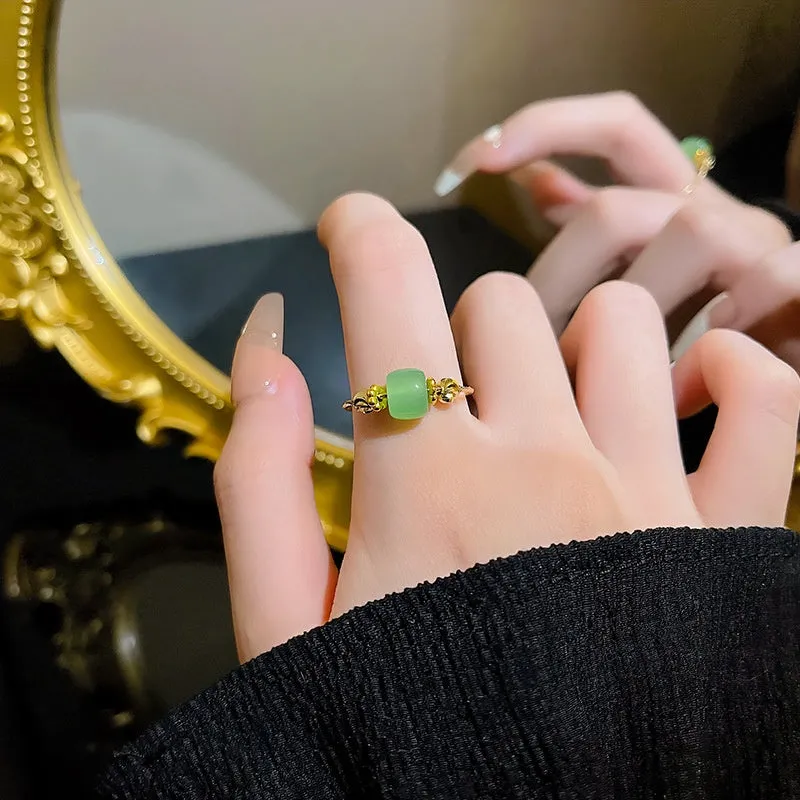 Geometric bow adjustable open ring in copper with electroplated gold finish on finger