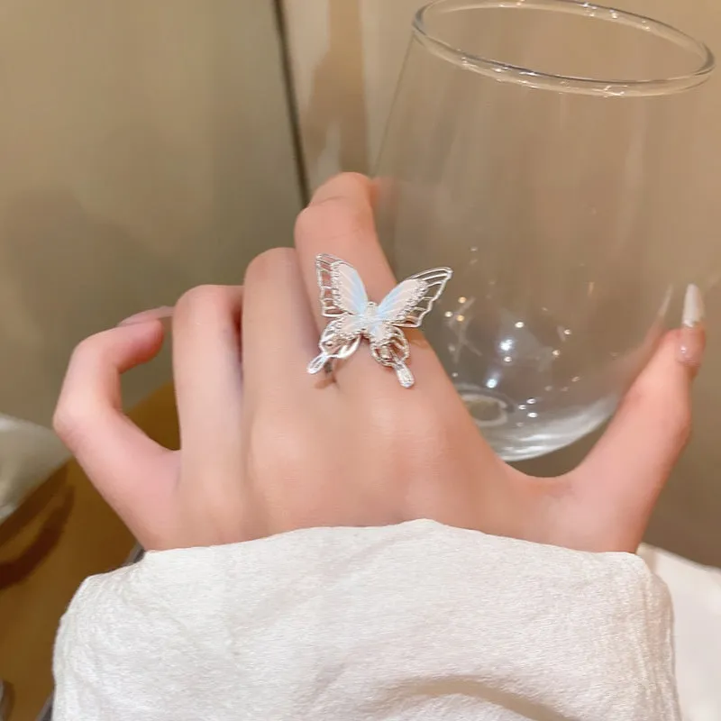 Geometric bow adjustable open ring in copper with electroplated gold finish on finger