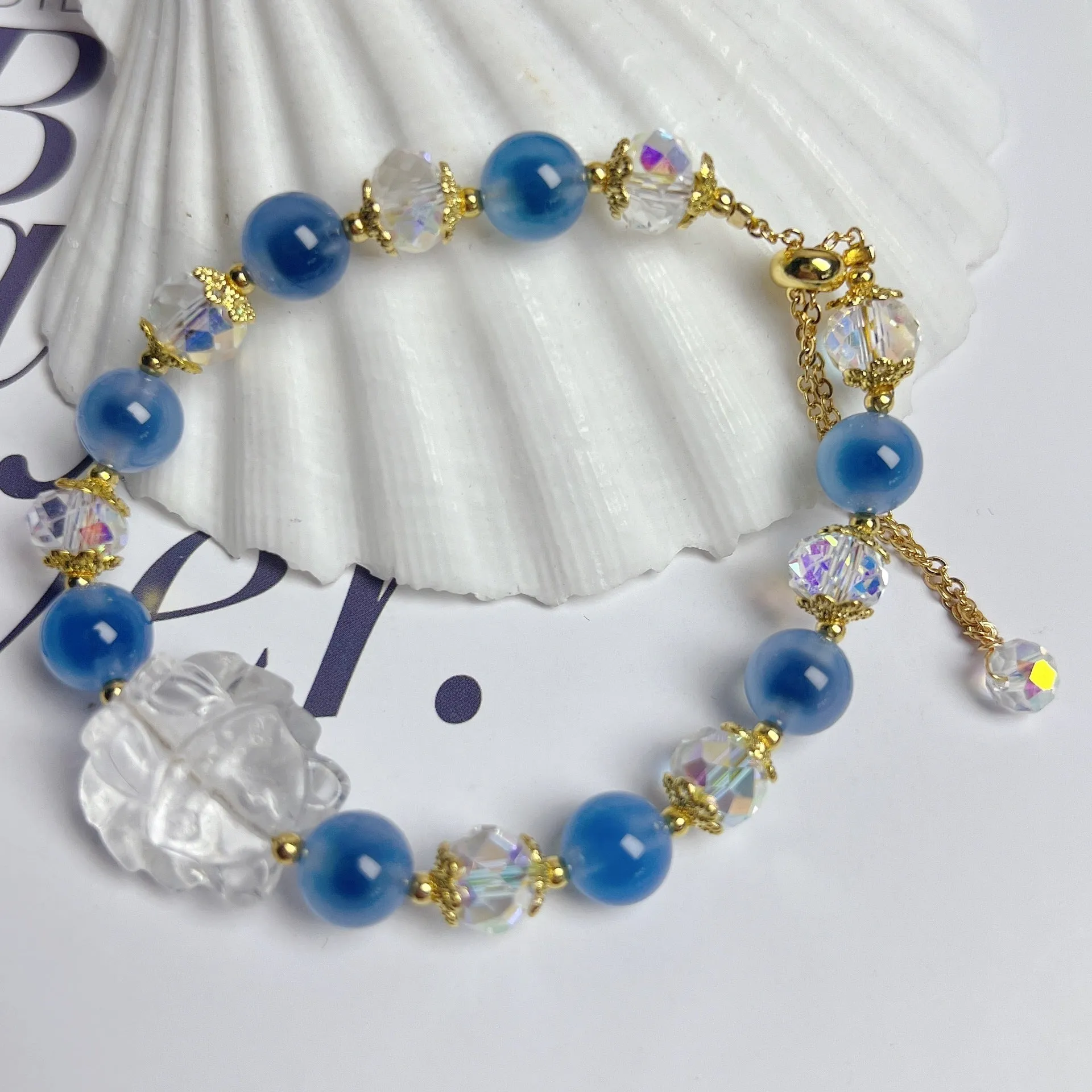 Handmade blue glazed agate nine tail fox bracelet on white background