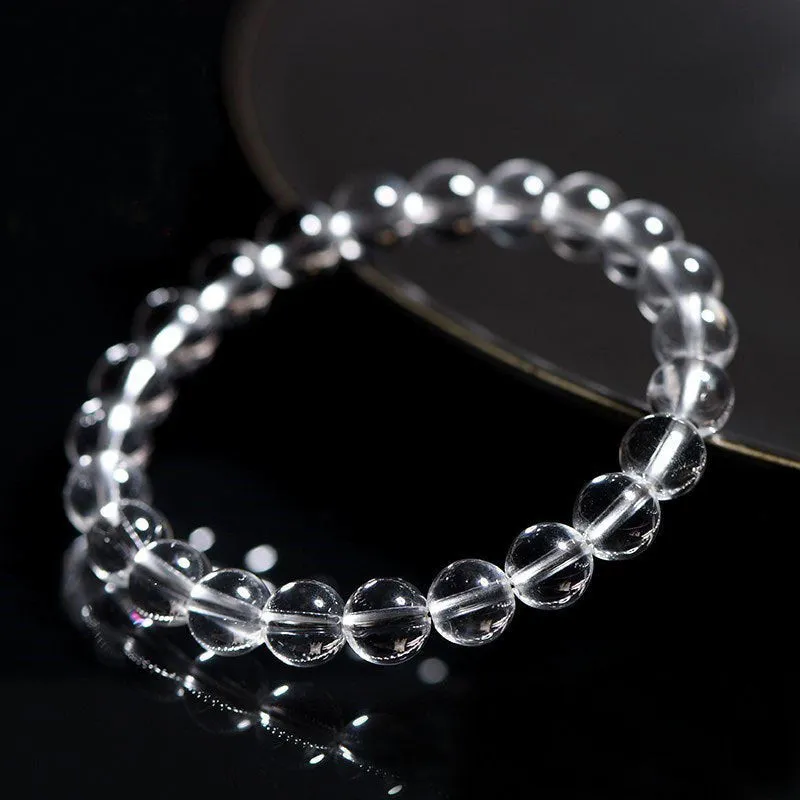 Natural old mine white crystal bracelet with round geometric beads on a wrist.