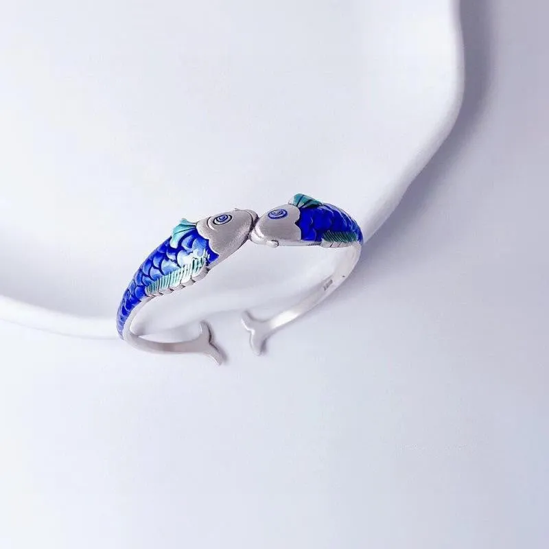 Silver electroplated copper bangle with blue carp design under glossy epoxy finish, 60mm diameter.