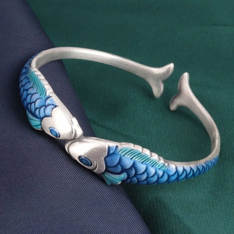 Silver electroplated copper bangle with blue carp design under glossy epoxy finish, 60mm diameter.