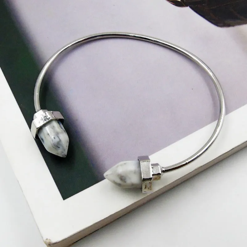 Natural alloy open-ended bracelet with inlaid gem turquoise style in silver blue finish on a neutral background