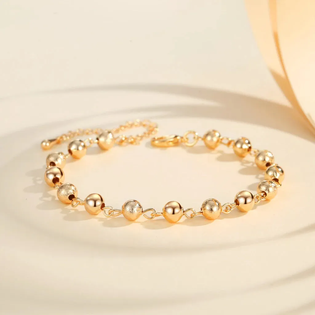 Gold electroplated copper unisex retro beaded bracelet on a neutral background