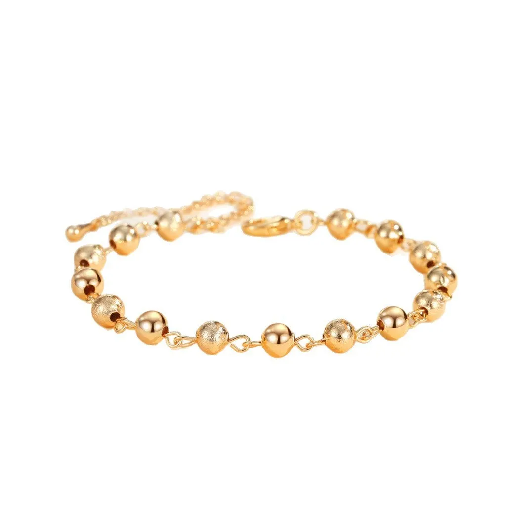 Gold electroplated copper unisex retro beaded bracelet on a neutral background