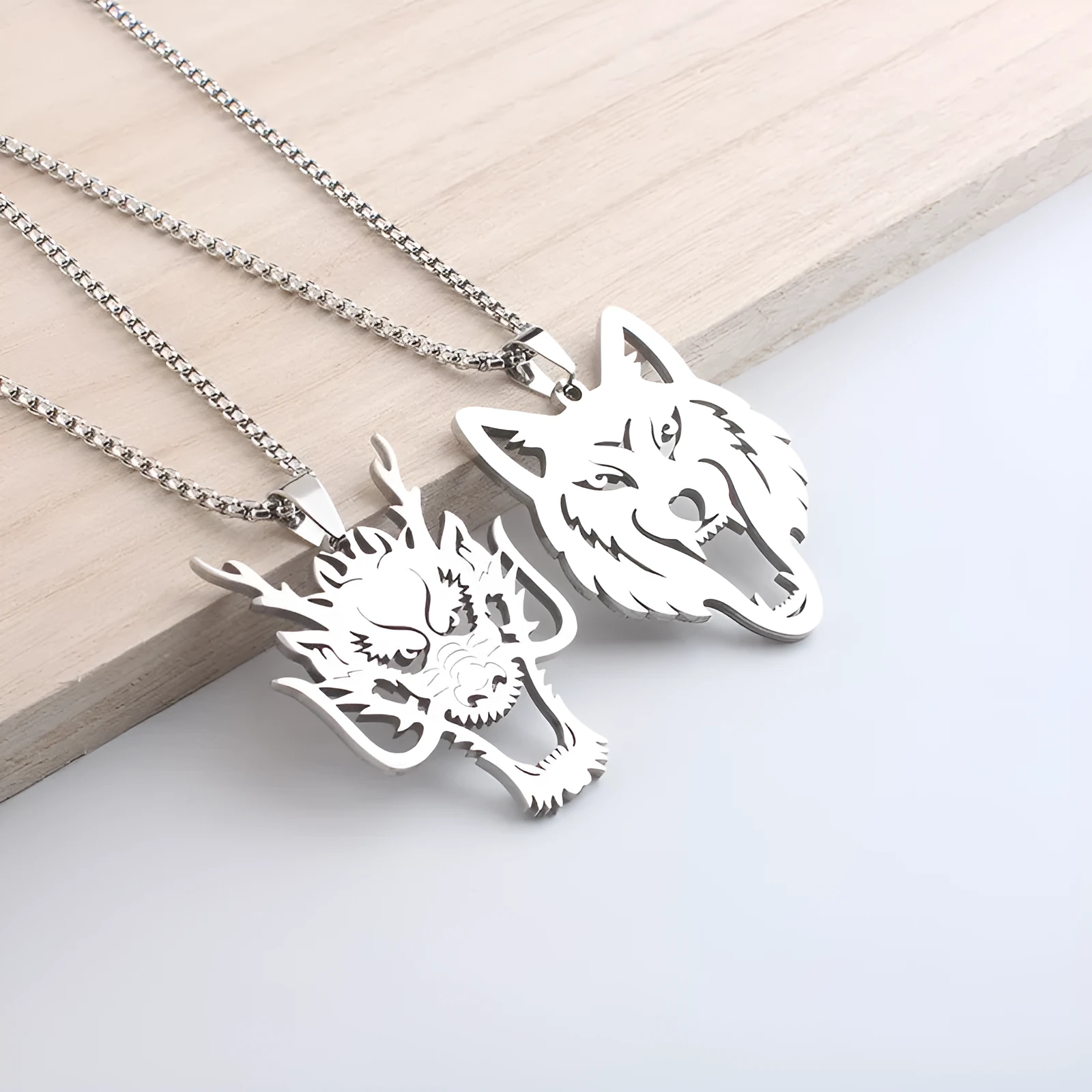 Hollow wolf head stainless steel pendant necklace with polished finish and 60cm chain on neutral background