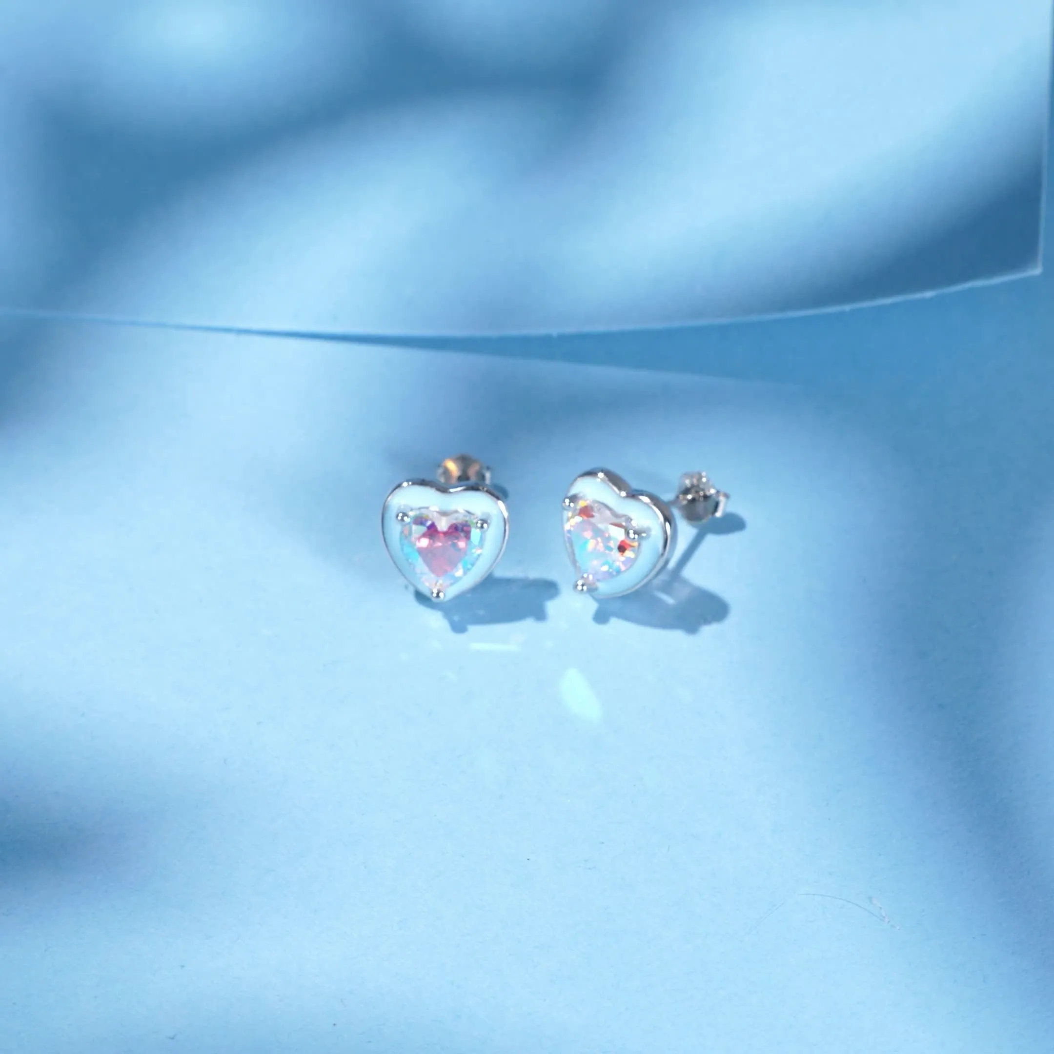 S925 sterling silver heart-shaped stud earrings with colourful zircon mosaic and epoxy accents on silver background