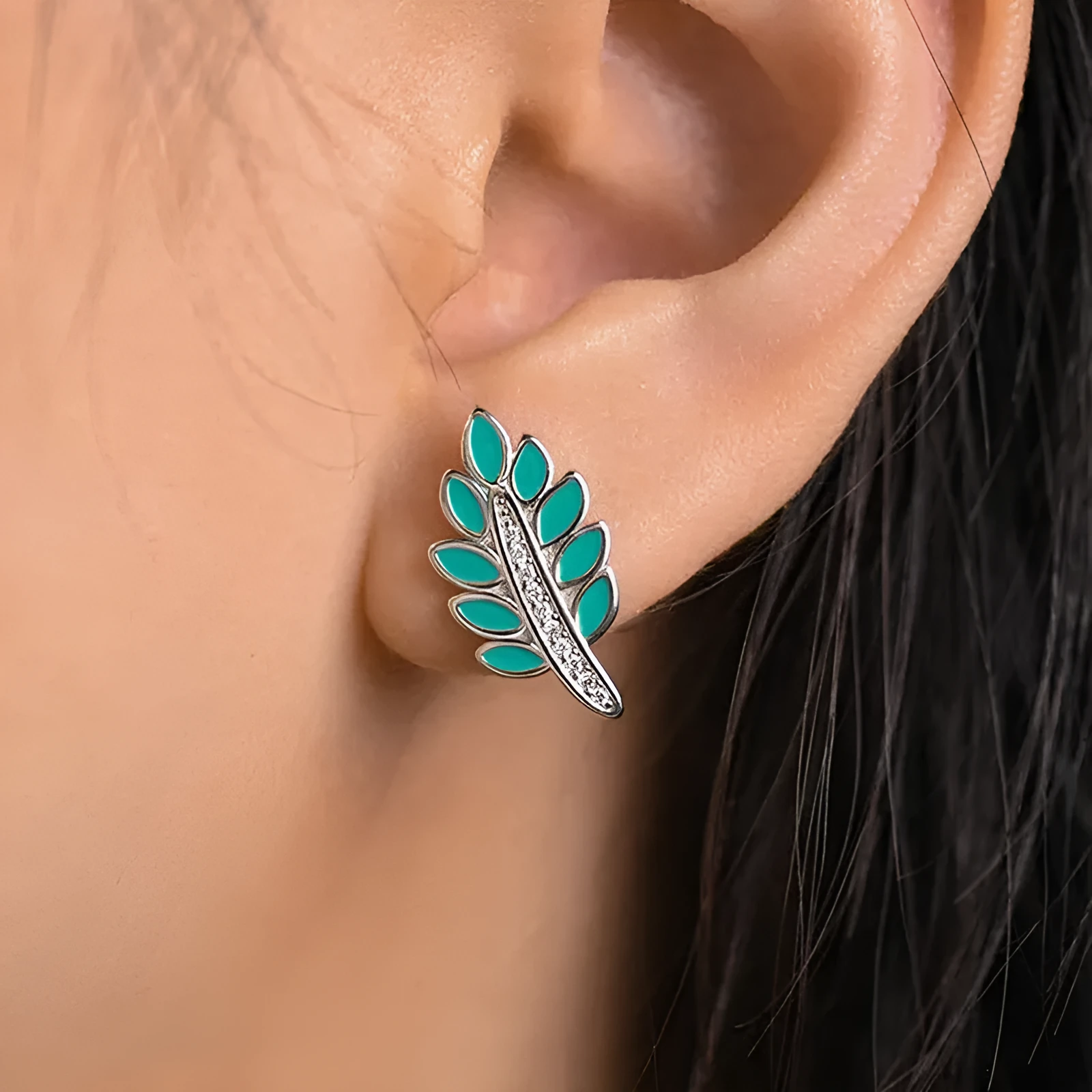 Pair of leaf-shaped copper stud earrings with white gold colour finish and inlaid zircon stone