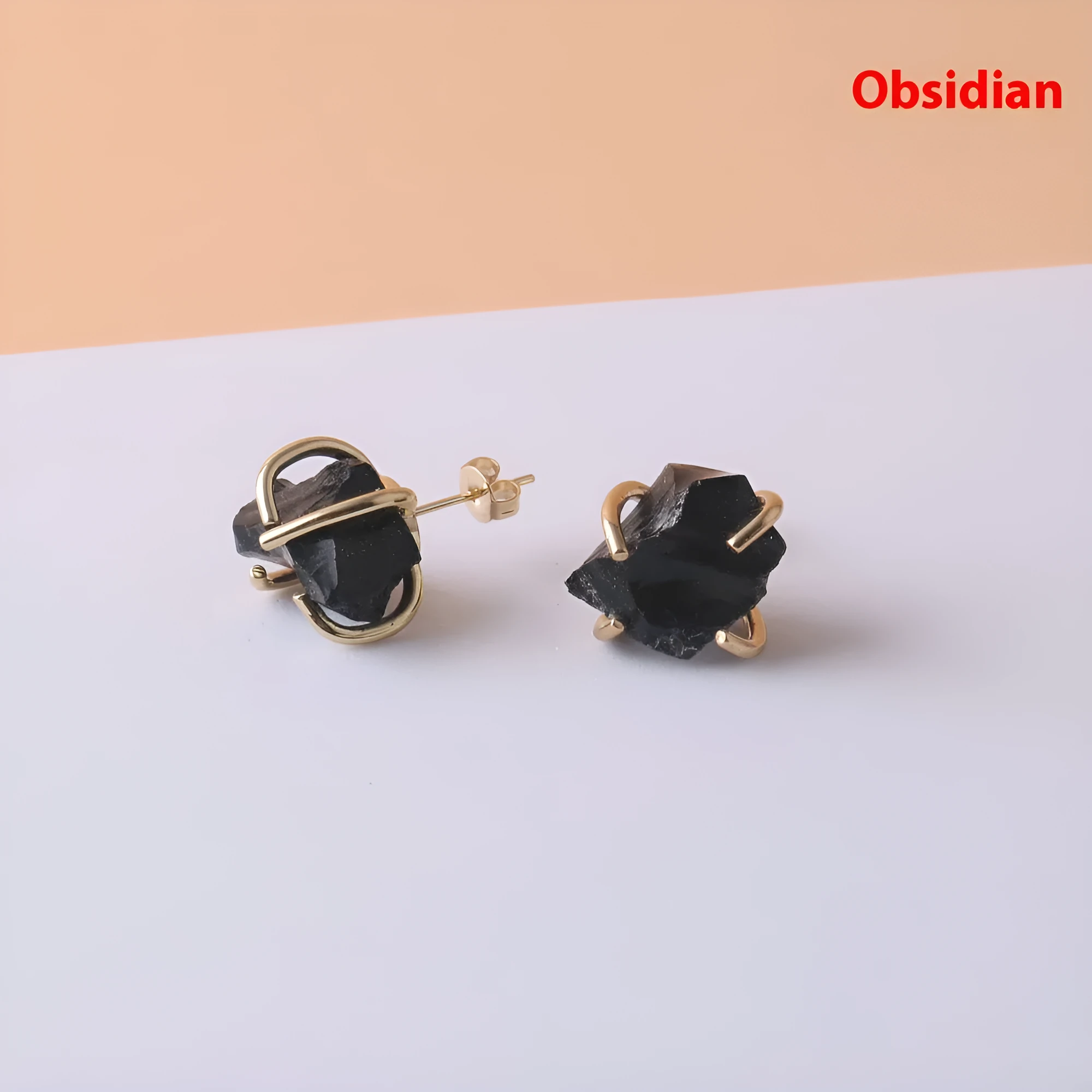 Rough stone crystal earrings with gold plated four claws on a black background