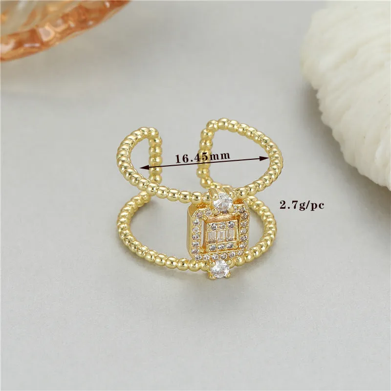 Gold-plated copper open ring with asymmetric U-shape and adjustable gap.