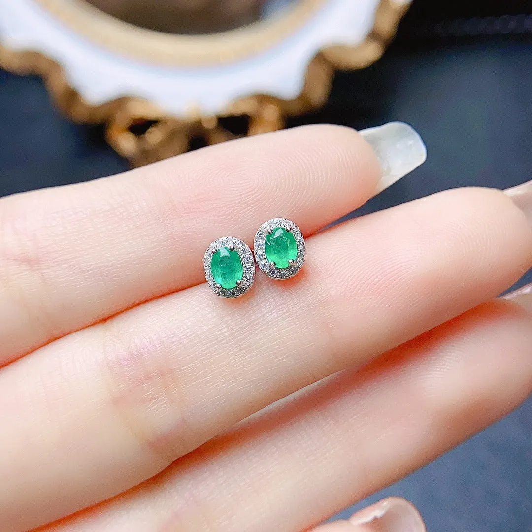 Natural emerald stud earrings in S925 silver with inlaid green main stone on white background
