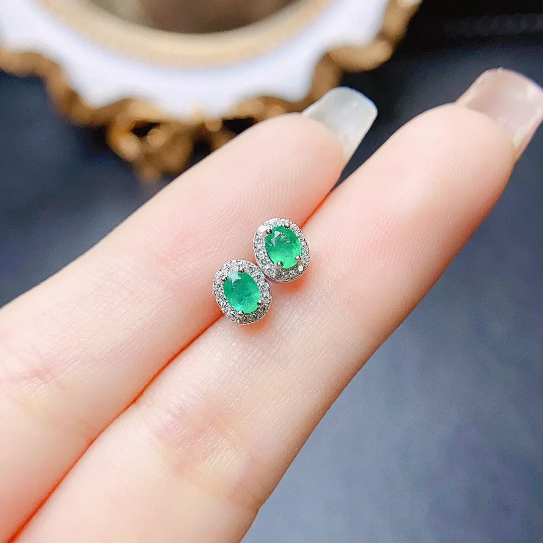 Natural emerald stud earrings in S925 silver with inlaid green main stone on white background
