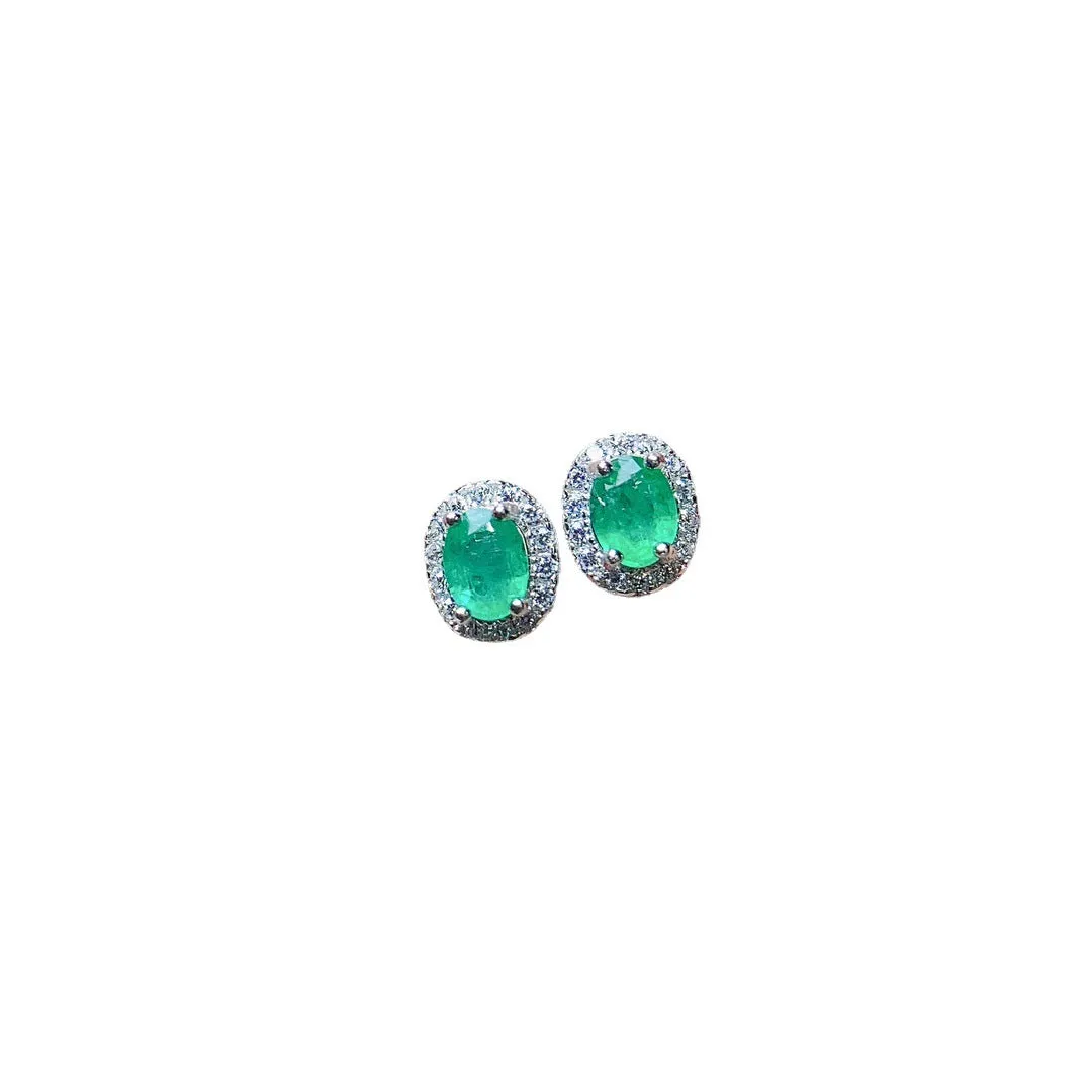 Natural emerald stud earrings in S925 silver with inlaid green main stone on white background