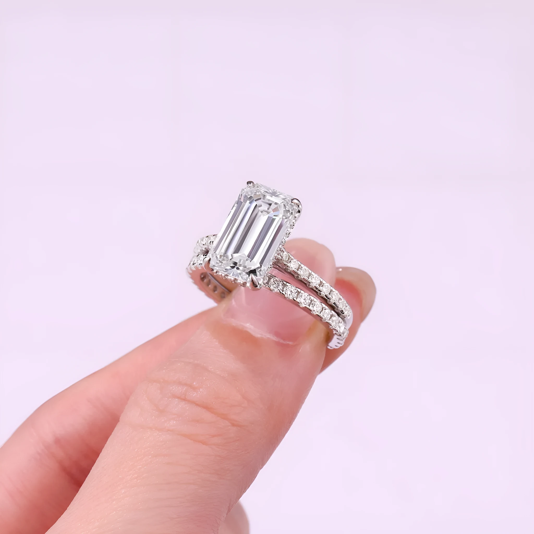 Pair of matching geometric S925 sterling silver rings with white finish on a flat surface