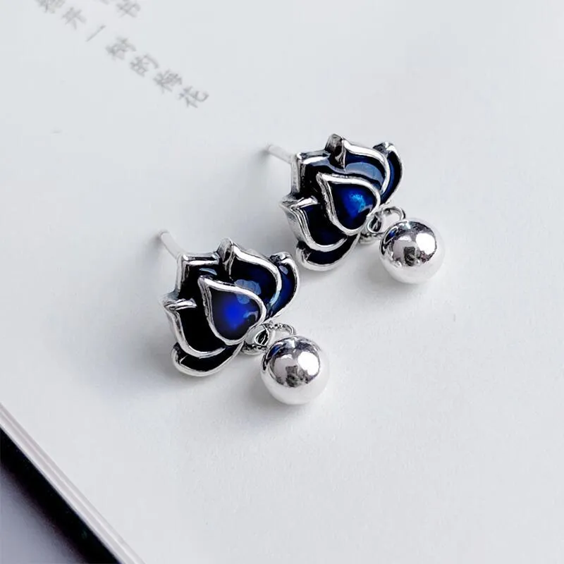 Blue lotus seedpod tassel ear studs with floral design on silver needle fittings