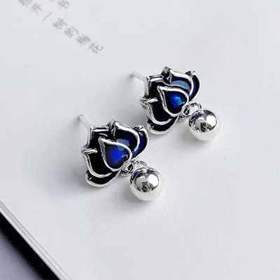 Blue lotus seedpod tassel ear studs with floral design on silver needle fittings