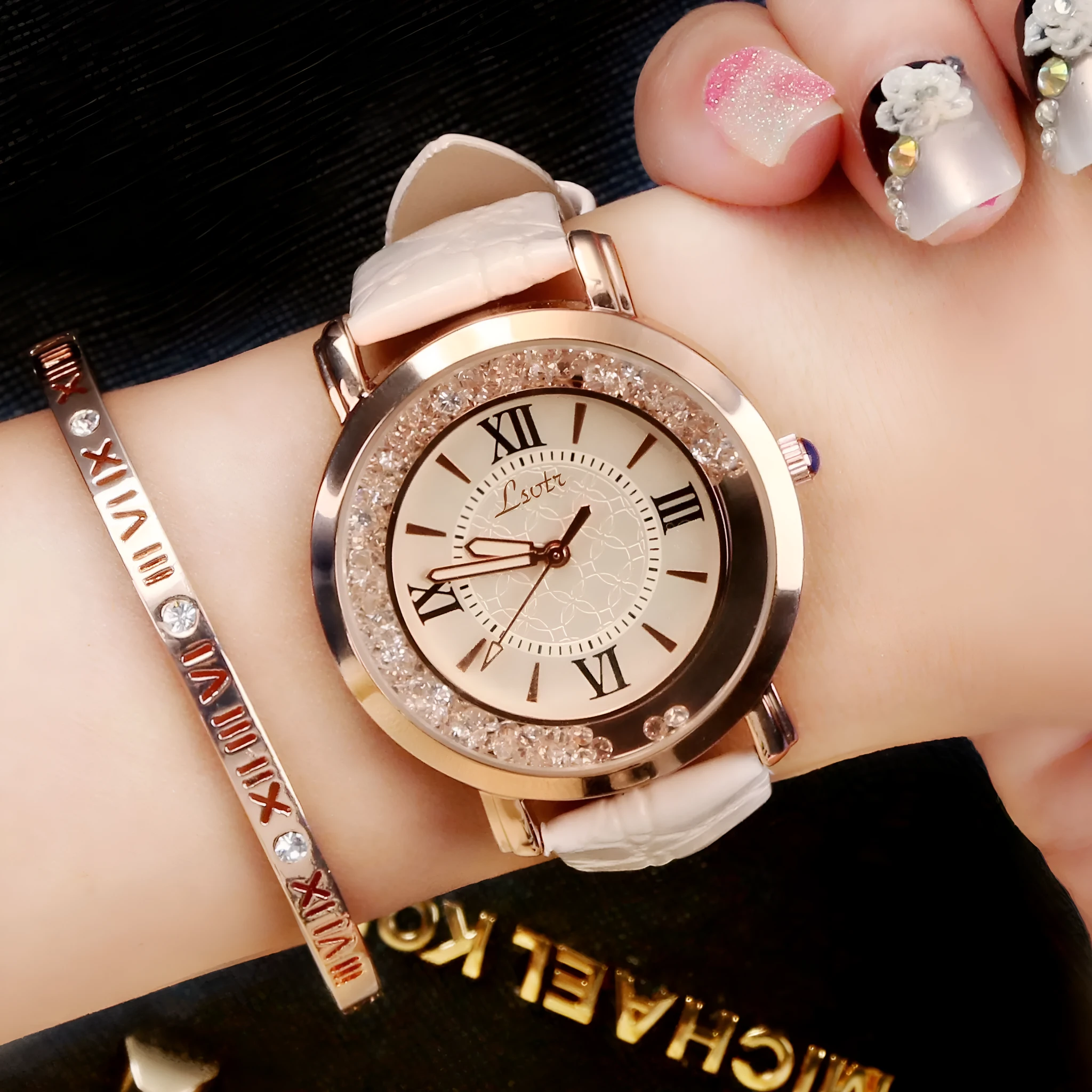 Ladies round metal case watch with white dial, rhinestone crown, and brown PU strap