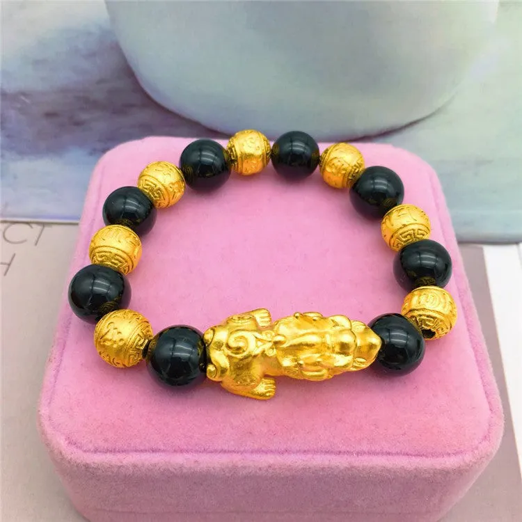 Vietnamese sand gold gold-plated brave bracelet with black beads on display