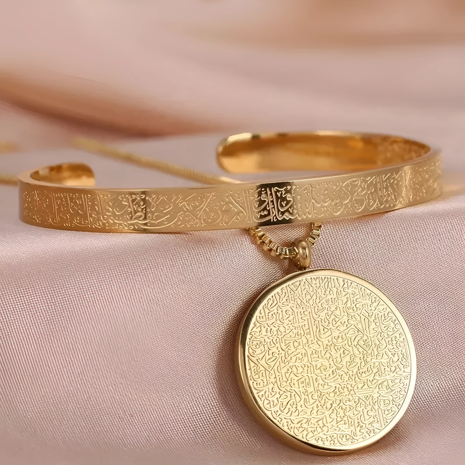 Polished stainless steel Arabic disc necklace and bracelet set in gold finish on white background