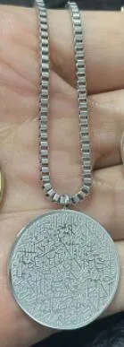Polished stainless steel Arabic disc necklace and bracelet set in gold finish on white background