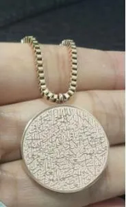 Polished stainless steel Arabic disc necklace and bracelet set in gold finish on white background