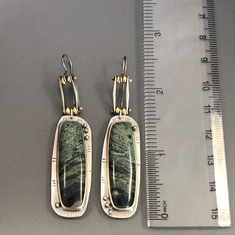A pair of simple geometric drop earrings with a grey and white marble pattern on an alloy background.