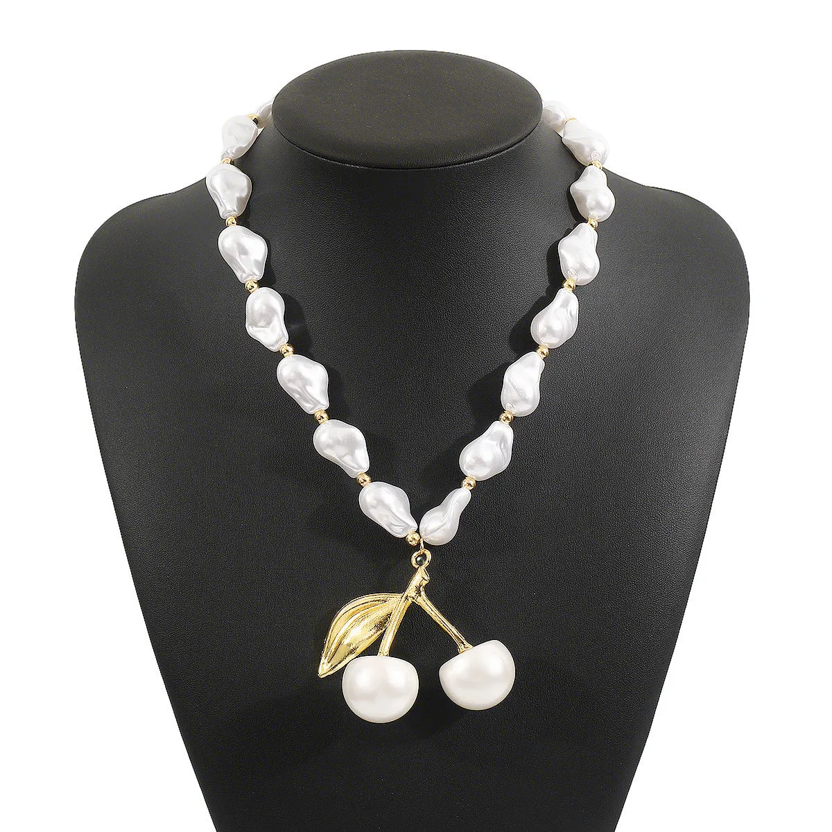 Gold-tone irregular cherry fruit pendant on an adjustable string of white imitation pearls necklace.