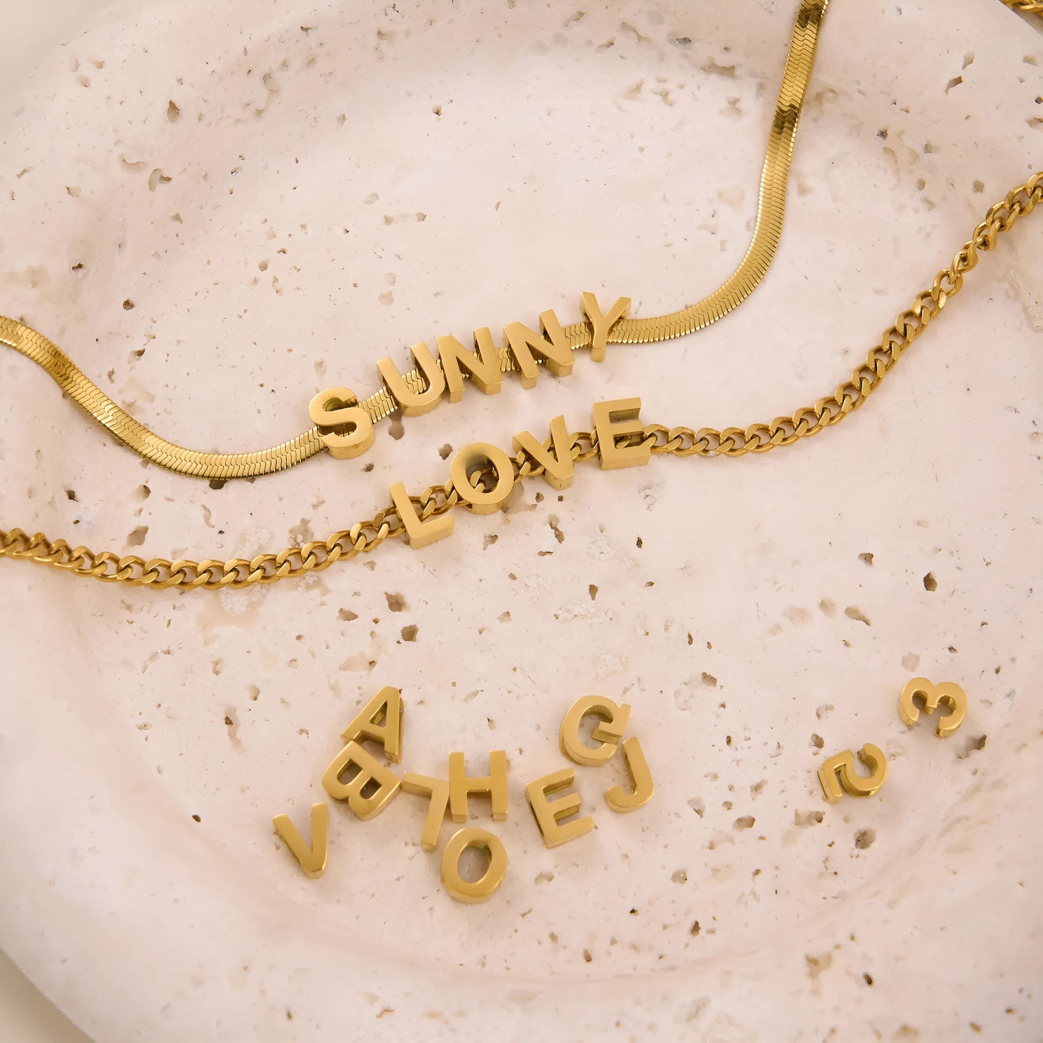 Gold or silver plated titanium steel necklace with a personalised letter, number, or heart pendant on a 40.5cm chain.