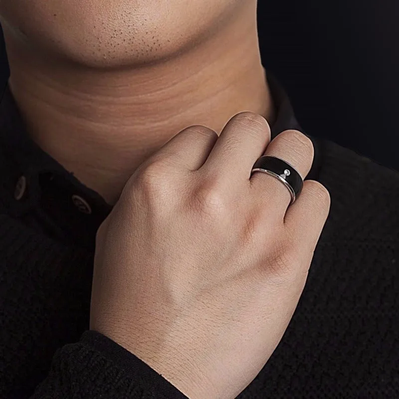 Black NFC multifunctional smart ring on finger for smartphone unlock, waterproof design