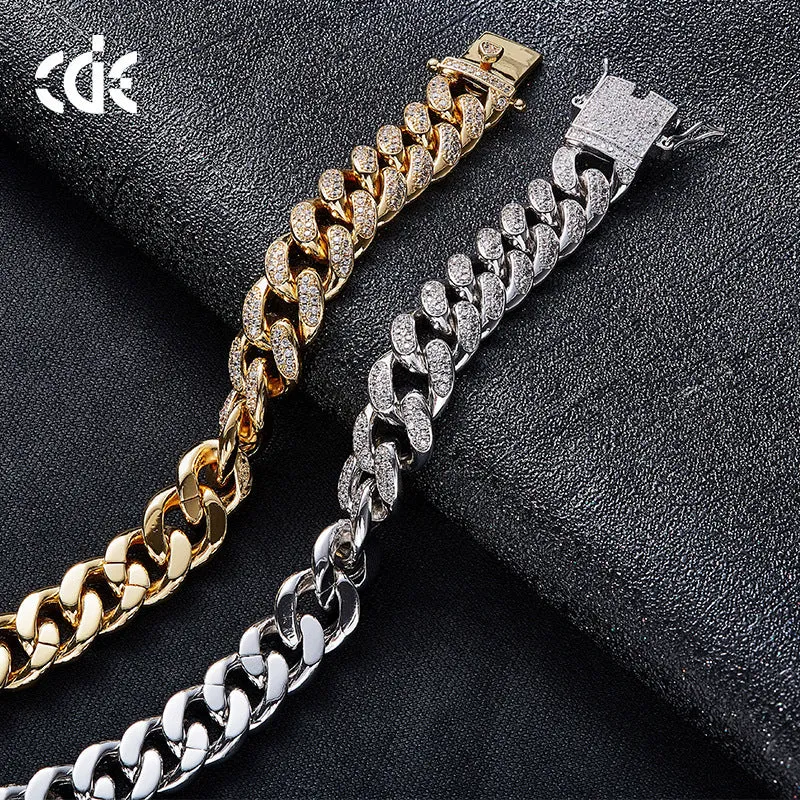 Men's Cuban chain bracelet with gold finish and geometric zircon pendant on a flat surface