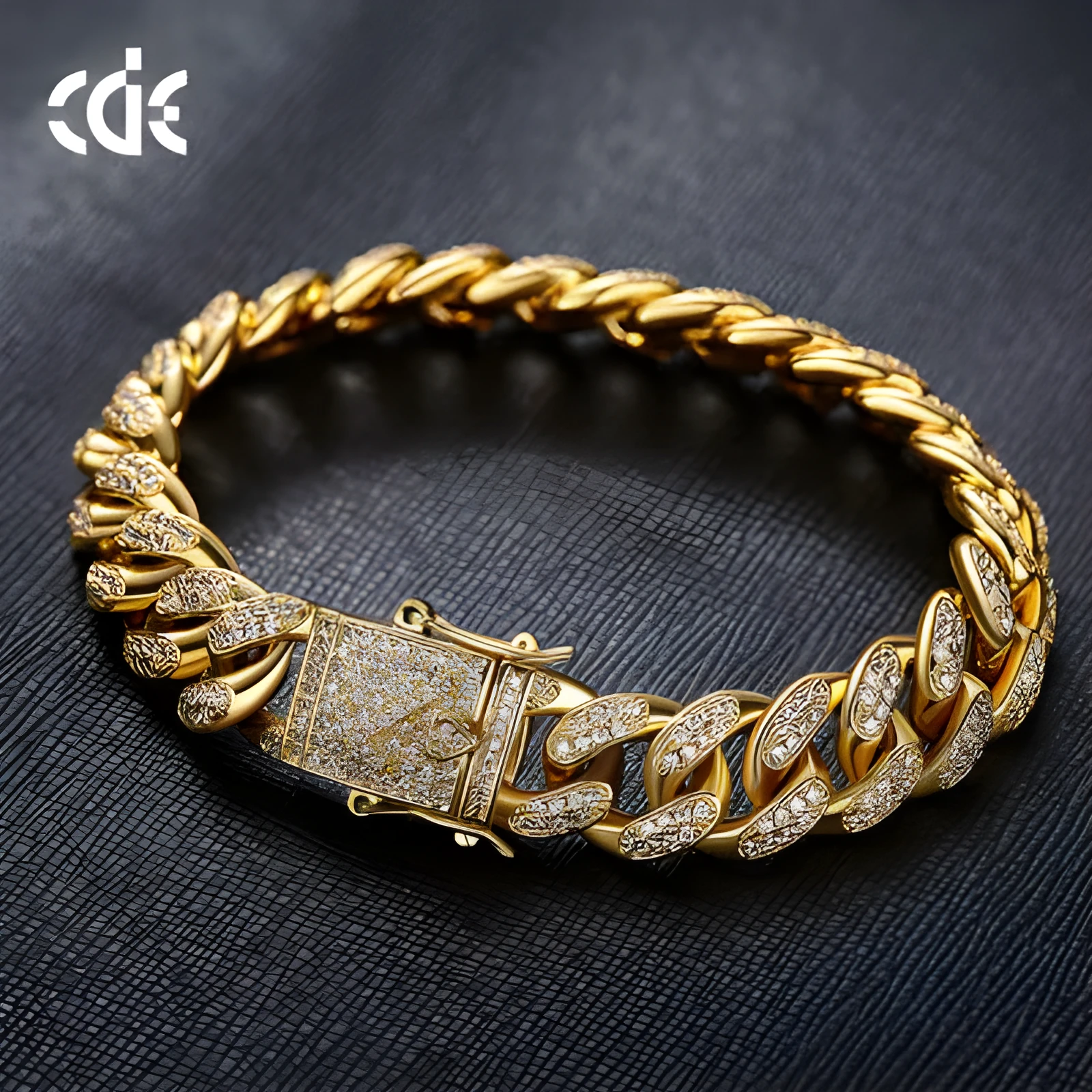 Men's Cuban chain bracelet with gold finish and geometric zircon pendant on a flat surface