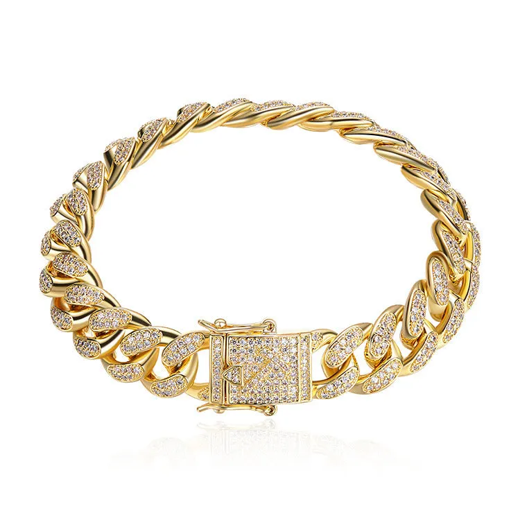 Men's Cuban chain bracelet with gold finish and geometric zircon pendant on a flat surface